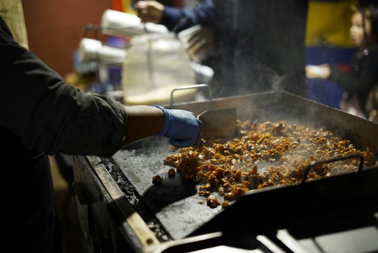 A person cooking on electric griddle